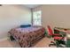 Bedroom featuring a bed, a window with natural light, and a small desk at 7162 Fringe Flower Dr, Austell, GA 30168