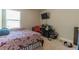Cozy bedroom featuring a bed, a desk area, and a wall-mounted television at 7162 Fringe Flower Dr, Austell, GA 30168