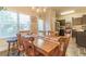 Dining room featuring an inviting wooden table, chandelier, and natural light near the kitchen at 7162 Fringe Flower Dr, Austell, GA 30168