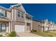 Well-maintained townhome exterior with landscaped front yard and attached garage at 7162 Fringe Flower Dr, Austell, GA 30168