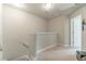 A simple hallway with carpeted floor and neutral walls leads to other rooms at 7162 Fringe Flower Dr, Austell, GA 30168