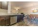 A stainless steel dishwasher and granite countertops in the kitchen looking towards the dining room at 7162 Fringe Flower Dr, Austell, GA 30168