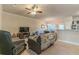 Open living space with ceiling fan and view of the kitchen at 7162 Fringe Flower Dr, Austell, GA 30168