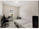 Well-lit bedroom with a window, computer desk, chair, and twin bed at 9007 Jim Purcell Dr, Covington, GA 30014