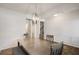 Elegant dining room with modern lighting, wood floors, and wainscoting at 9007 Jim Purcell Dr, Covington, GA 30014