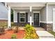 Inviting front porch with stone accents, manicured landscaping, and a stylish front door at 9007 Jim Purcell Dr, Covington, GA 30014