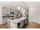 Stylish kitchen with gray cabinets, granite counters, stainless appliances, island seating, and a pantry at 9007 Jim Purcell Dr, Covington, GA 30014