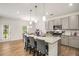 Modern kitchen featuring stainless steel appliances, granite counters, a central island, and barstool seating at 9007 Jim Purcell Dr, Covington, GA 30014