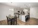 Modern kitchen with gray cabinets, granite countertops, stainless appliances and an island with seating at 9007 Jim Purcell Dr, Covington, GA 30014