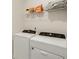 Laundry area complete with washer, dryer and storage shelving at 9007 Jim Purcell Dr, Covington, GA 30014