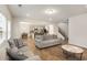 Spacious living room with wood floors, open concept kitchen, and plenty of natural light at 9007 Jim Purcell Dr, Covington, GA 30014