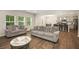 Bright and airy living room with an open floor plan and a view of the modern kitchen at 9007 Jim Purcell Dr, Covington, GA 30014