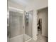 Tiled walk-in shower with glass door, with a view leading to a walk-in closet at 9007 Jim Purcell Dr, Covington, GA 30014
