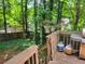 Backyard deck featuring grill and with view of yard with wooden fence and mature trees at 215 Boca Ciega Ct, Alpharetta, GA 30022