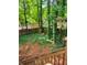 Secluded backyard with a wooden fence and mature trees creating a private outdoor space at 215 Boca Ciega Ct, Alpharetta, GA 30022