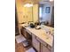 Bathroom featuring double vanity, a large mirror, and a glimpse of a bathtub in the background at 215 Boca Ciega Ct, Alpharetta, GA 30022