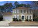 Charming two-story home with attached garage and traditional architectural details at 215 Boca Ciega Ct, Alpharetta, GA 30022