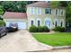 Charming two-story home with attached garage and well-manicured lawn at 215 Boca Ciega Ct, Alpharetta, GA 30022