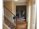Inviting foyer featuring hardwood floors, a staircase with wooden banister, and views into adjoining rooms at 215 Boca Ciega Ct, Alpharetta, GA 30022