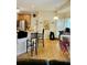 Bright kitchen with stainless steel refrigerator, bar seating, and hardwood flooring at 215 Boca Ciega Ct, Alpharetta, GA 30022