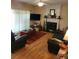 Comfortable living room with a fireplace, flat screen television, and hardwood floors at 215 Boca Ciega Ct, Alpharetta, GA 30022