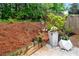 Landscaped backyard featuring stylish planters and wood fencing at 2939 Woodward Down Trl, Buford, GA 30519