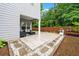 Backyard patio area with stone tiling and elegant outdoor seating at 2939 Woodward Down Trl, Buford, GA 30519