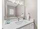 Modern bathroom with a large mirror, white countertops, and elegant fixtures at 2939 Woodward Down Trl, Buford, GA 30519