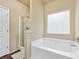 Bathroom with white tub and separate shower at 2939 Woodward Down Trl, Buford, GA 30519