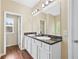Bathroom vanity with double sinks and dark countertops at 2939 Woodward Down Trl, Buford, GA 30519