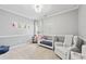 Serene bedroom with a crib, recliner, and cheerful superhero decor at 2939 Woodward Down Trl, Buford, GA 30519