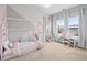 bedroom featuring decoratively painted wall, neutral carpet, and plenty of sunlight at 2939 Woodward Down Trl, Buford, GA 30519