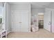 Bright bedroom featuring a closet, neutral walls, and a cozy chair at 2939 Woodward Down Trl, Buford, GA 30519