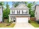 Charming two-story home with stone accents, a two-car garage, and manicured landscaping at 2939 Woodward Down Trl, Buford, GA 30519