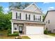 Attractive two-story house features stone accents and black shutters, enhancing curb appeal at 2939 Woodward Down Trl, Buford, GA 30519