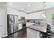 Bright kitchen with stainless steel appliances, white cabinetry, and granite countertops at 2939 Woodward Down Trl, Buford, GA 30519