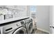 Well-lit laundry room features modern appliances and sleek countertops at 2939 Woodward Down Trl, Buford, GA 30519