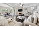 Cozy living room featuring a stone fireplace, dark hardwood floors, and a modern white coffee table at 2939 Woodward Down Trl, Buford, GA 30519