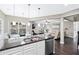 Open-concept kitchen and living space with hardwood floors and lots of natural light at 2939 Woodward Down Trl, Buford, GA 30519