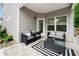 Inviting covered patio with comfortable seating and a modern outdoor rug at 2939 Woodward Down Trl, Buford, GA 30519