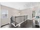 Upstairs landing featuring dark wood floors, light gray walls, and views to a bedroom at 2939 Woodward Down Trl, Buford, GA 30519
