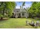 Lush backyard with firepit, deck, mature trees, and a fenced perimeter at 4404 Old Georgetown Trl, Atlanta, GA 30338