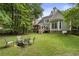 Well-maintained backyard with a firepit area, deck, and lush greenery at 4404 Old Georgetown Trl, Atlanta, GA 30338