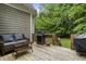 Outdoor deck with seating and a grill overlooking a lush, private backyard at 4404 Old Georgetown Trl, Atlanta, GA 30338