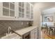 Chic bar area with sleek countertops, glass-front cabinets, and a wine cooler at 4404 Old Georgetown Trl, Atlanta, GA 30338