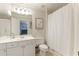 Bright bathroom with white vanity, shower with tub, white shower curtain, and picture at 4404 Old Georgetown Trl, Atlanta, GA 30338