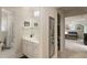 Well-lit bathroom with a white vanity, mirror, and access to additional rooms at 4404 Old Georgetown Trl, Atlanta, GA 30338
