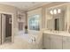 Relaxing bathroom showcasing a soaking tub, window, and modern white vanity at 4404 Old Georgetown Trl, Atlanta, GA 30338