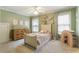 Cozy ' bedroom featuring soft colors, a cute bed, and a rainbow bookshelf at 4404 Old Georgetown Trl, Atlanta, GA 30338