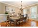 Formal dining room featuring a chandelier, wainscoting, and a sideboard at 4404 Old Georgetown Trl, Atlanta, GA 30338